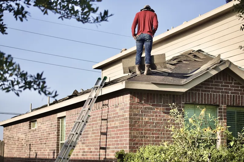 Professional roofer working on a residential roof in Oakbrook